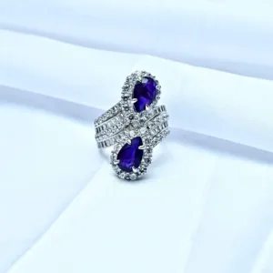 twin blue teardrop 925 silver ring displayed on white fabric