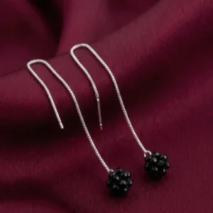 Pair of black cluster 925 silver drop earrings on burgundy fabric