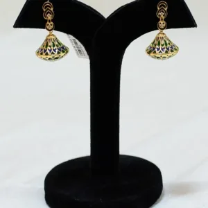 Pair of green and blue gold plated jhumka earrings on black display stand