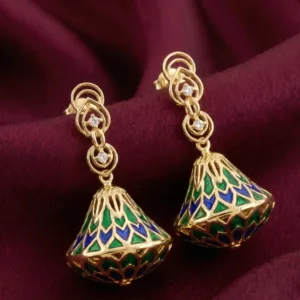 Pair of Meher gold plated jhumka earrings on burgundy fabric