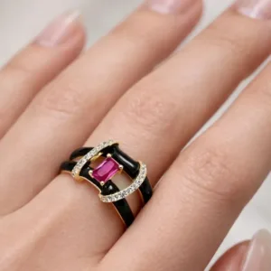 golden black and pink statement ring worn on finger