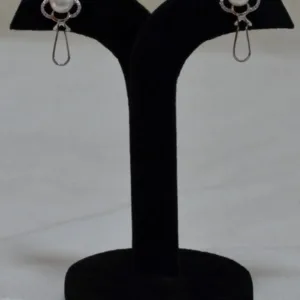 Pair of floral silver stud earrings on black display stand