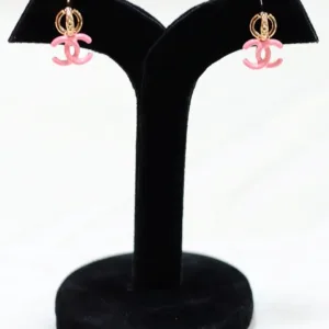 Pair of pink double-C gold plated earrings on black display stand