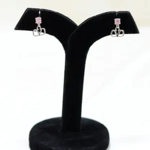 Pair of pink V-motif silver drop earrings on black display stand