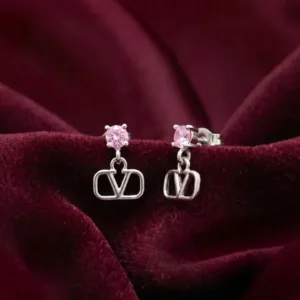Pair of pink V-motif 925 silver drop earrings on burgundy fabric